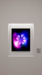 Framed artwork with a colorful flower design on a gray wall.
