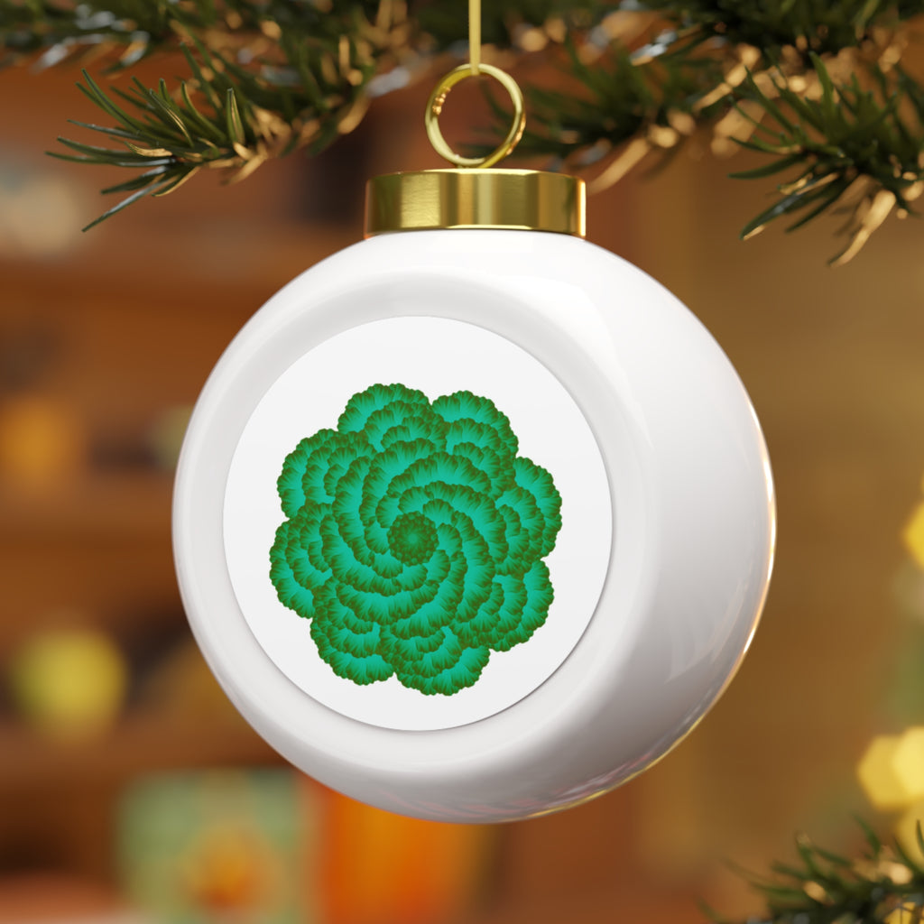 Decorative ornament with green floral design on a white background, hanging from a tree.