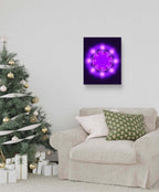 Living room with a decorated Christmas tree and a wall art piece featuring a purple light design.
