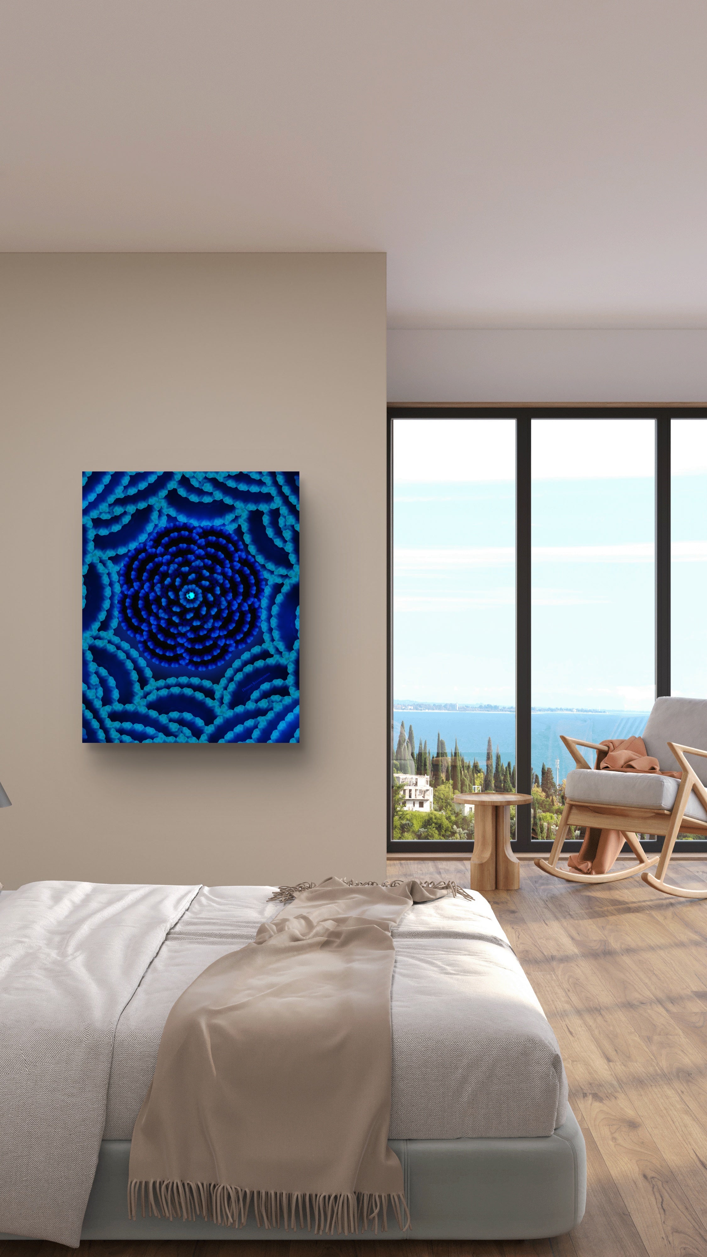 Blue abstract painting on a wall above a bed with a view of the ocean.